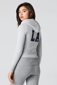Haut à capuchon en tricot jacquard et glissière
