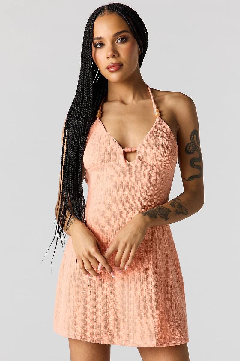 Minirobe bain-de-soleil en tricot avec billes