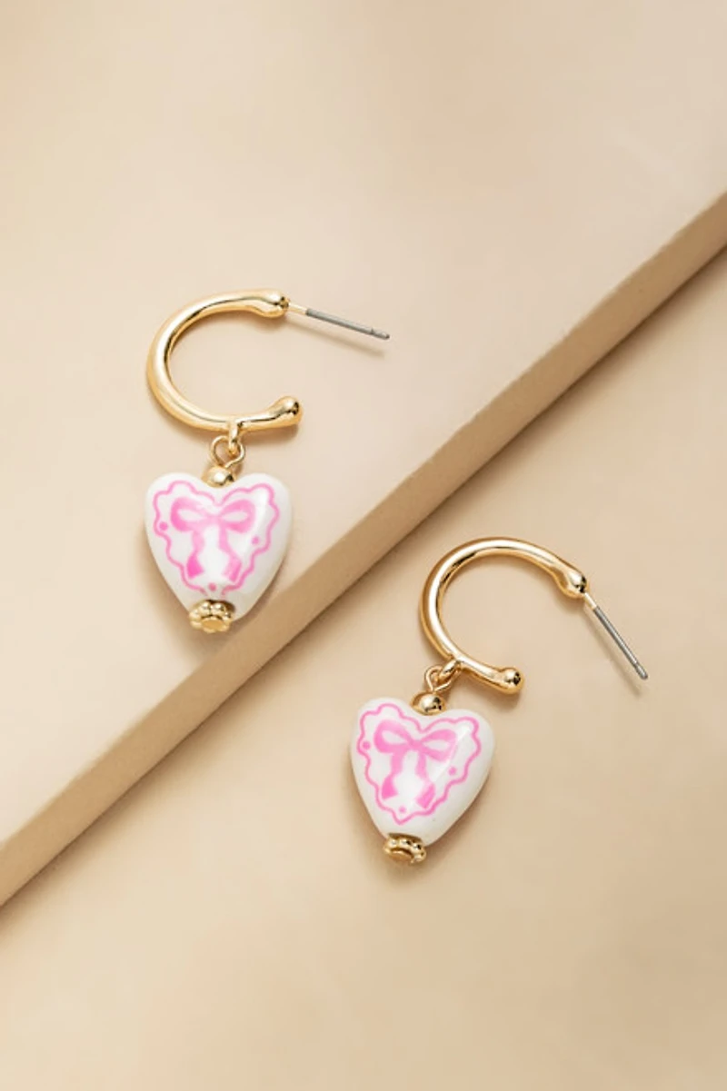 Sharon Bow On Ceramic Heart Huggie Earrings