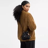 Faye Mini Drawstring Bag In Signature Denim