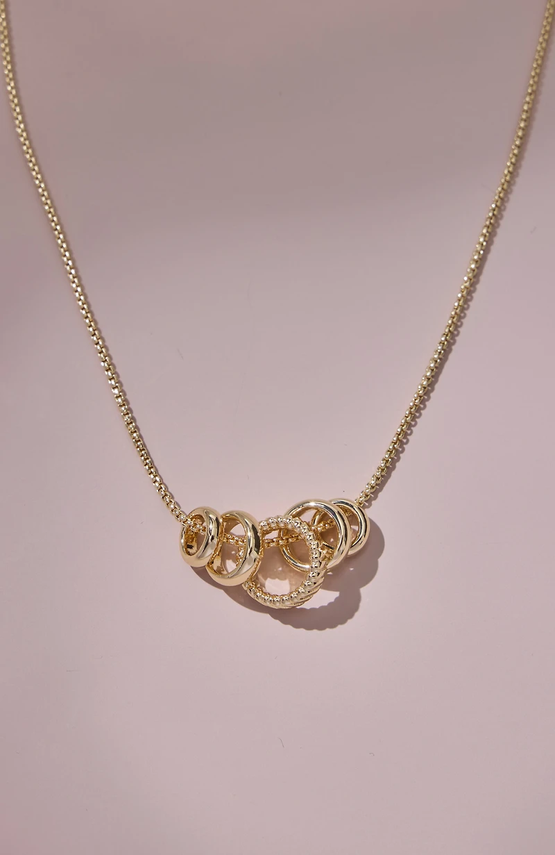 compassion fund five golden rings necklace