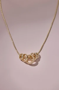 compassion fund five golden rings necklace