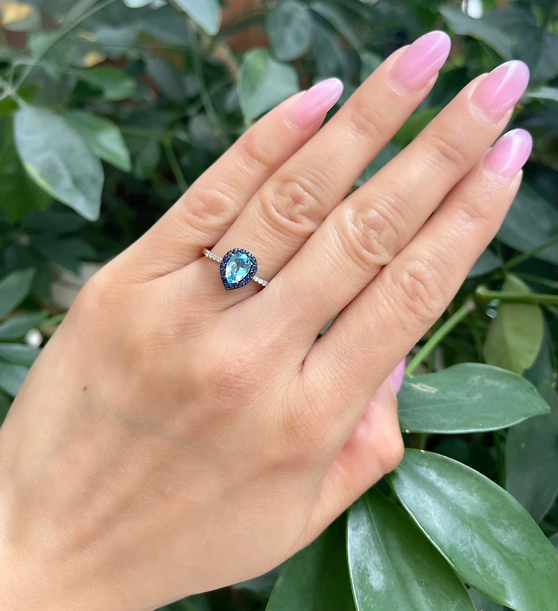 10K White Gold 7x5mm Pear Cut Sky Blue Topaz with Blue Sapphire Halo and 0.10cttw Diamond Ring - 4.5