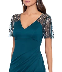 Xscape Short Beaded Sheer Flutter Sleeve Cascading Draped Waist V-Neck Beaded Gown