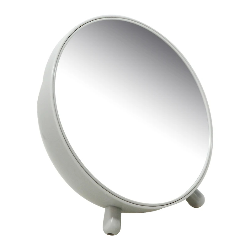 round navy vanity mirror with makeup brush storage