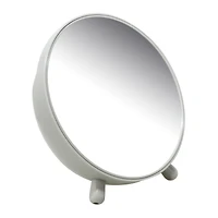 round navy vanity mirror with makeup brush storage