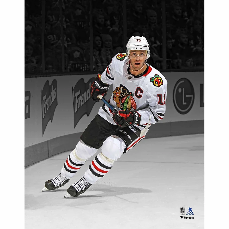 Jonathan Toews Chicago Blackhawks Unsigned White Jersey Skating Spotlight Photograph