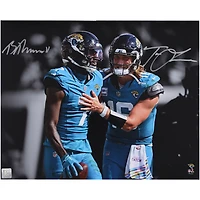 Trevor Lawrence & Brian Thomas Jr. Jacksonville Jaguars Autographed 16" x 20" Teal Jersey Spotlight Photograph