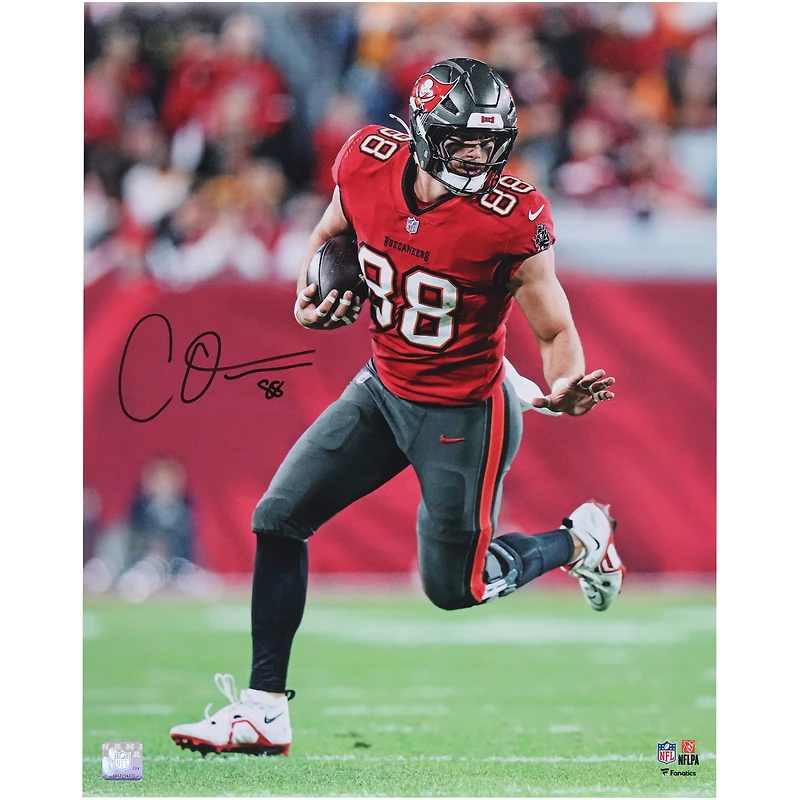 Cade Otton Tampa Bay Buccaneers Autographed 16" x 20" Red Jersey Running with Ball Photograph