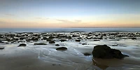 Ted Ray - Sunset over Beach with Rocks