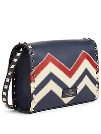 Medium Rockstud Leather Crossbody Bag In Chevron