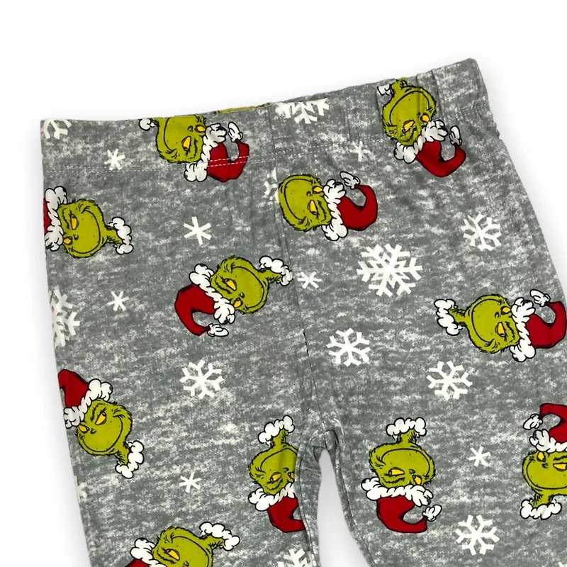The Grinch Legging imprimé fille. Ces leggings longs pour filles ont une ceinture élastique et peuvent être portés avec n'importe quel haut et