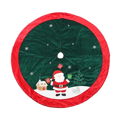 Holiday Time Velvet Santa Tree Skirt, 48 in, Multi-colour, Christmas Tree Skirt,Velvet material,base dark green color,trim red color,Santa is standing on the snow ground,holding green and red gift bags with “HO” embroidered on it.There are flowers on the snow ground,a house on back of the Santa.