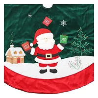 Jupe d'arbre de Père Noël en velours, 48 pouces, multi couleur Jupe d'arbre de Noël,matériau de velours,couleur vert foncé de base,couleur rouge de garniture,le Père Noël se tient sur le sol enneigé,tenant des sacs cadeaux verts et rouges avec "HO" brodé sur lui.Il y a des fleurs sur le sol enneigé,une maison au dos du Père Noël.