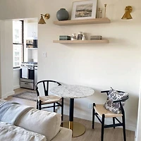 Round Dining Table combines timeless elegance with contemporary design.Luxurious faux marble top, brushed gold detailing, and a sturdy matte black base.
