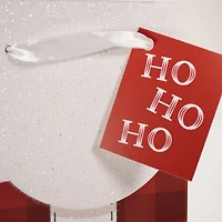 Sac cadeau en papier de Noël avec ceinture rouge du Père Noël et petit vin