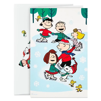 Boîte de 24 cartes de Noël Connections de Hallmark (La bande Peanuts fait du patin à glace)