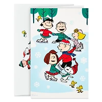 Boîte de 24 cartes de Noël Connections de Hallmark (La bande Peanuts fait du patin à glace)