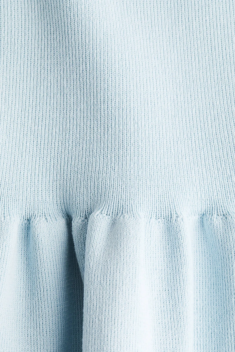 Haut péplum en tricot