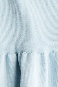 Haut péplum en tricot