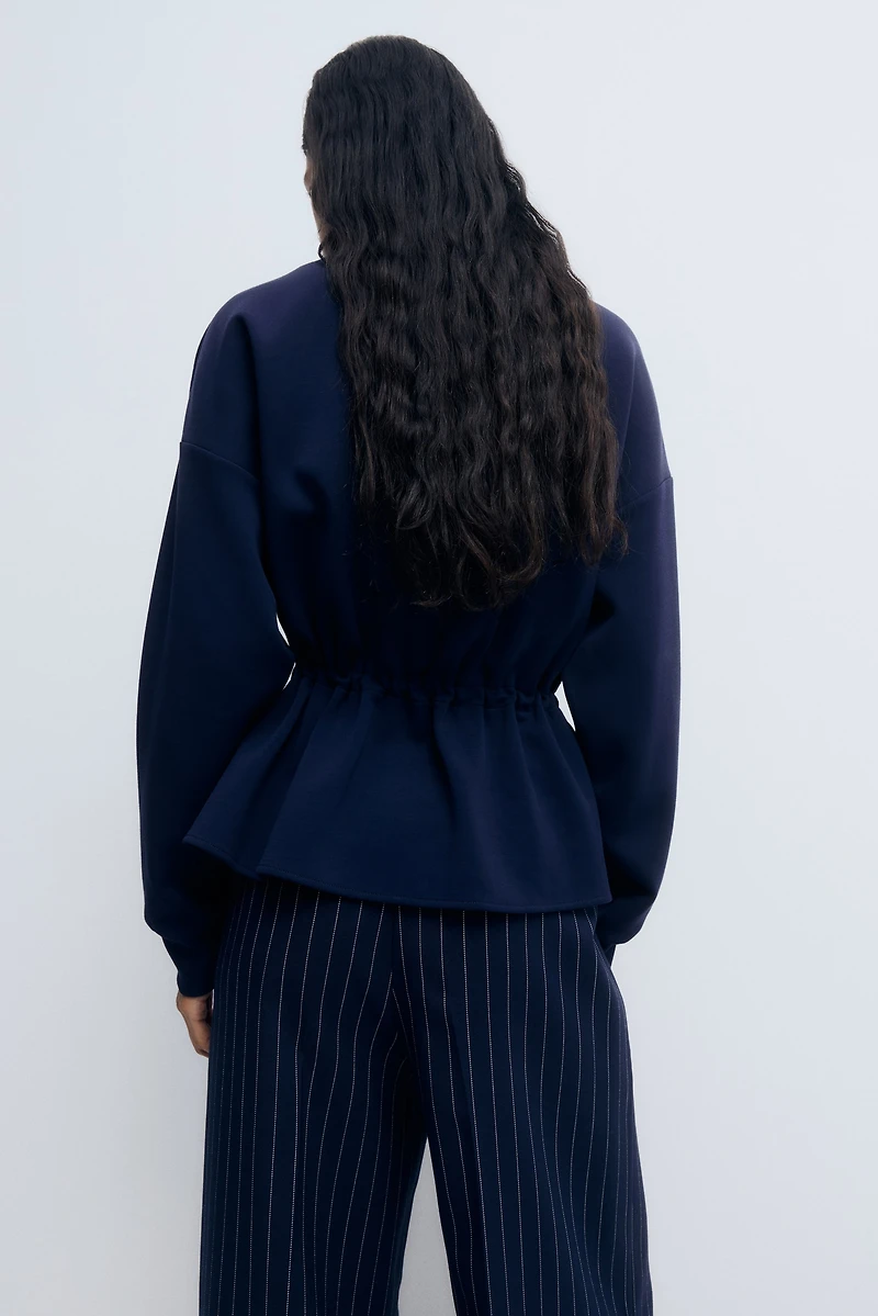 Chandail péplum à fermeture éclair