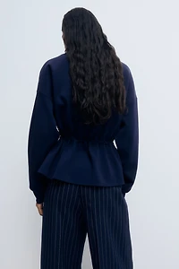 Chandail péplum à fermeture éclair