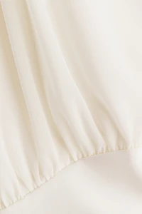 Haut sans manches à effet drapé