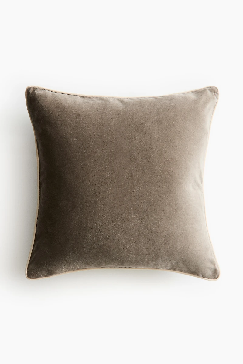 Housse de coussin en velours avec passepoil