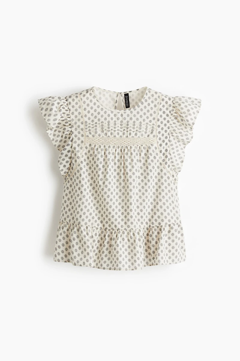 Blouse péplum avec dentelle