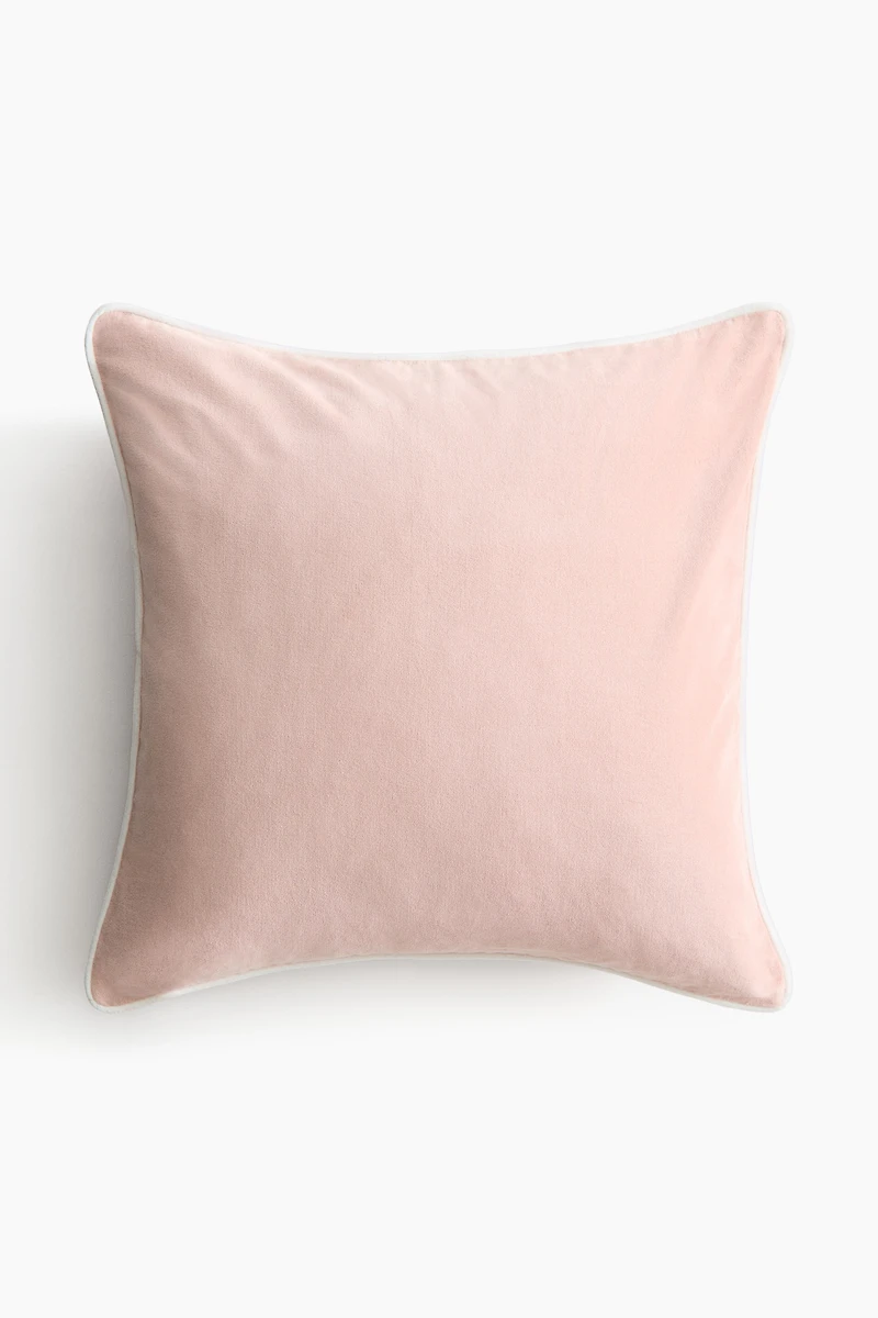 Housse de coussin en velours avec passepoil