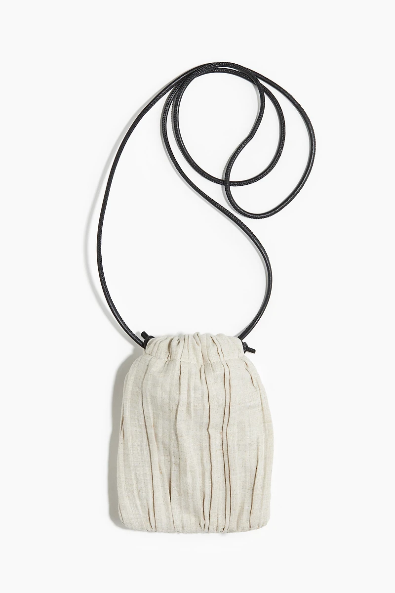 Linen-blend drawstring phone bag