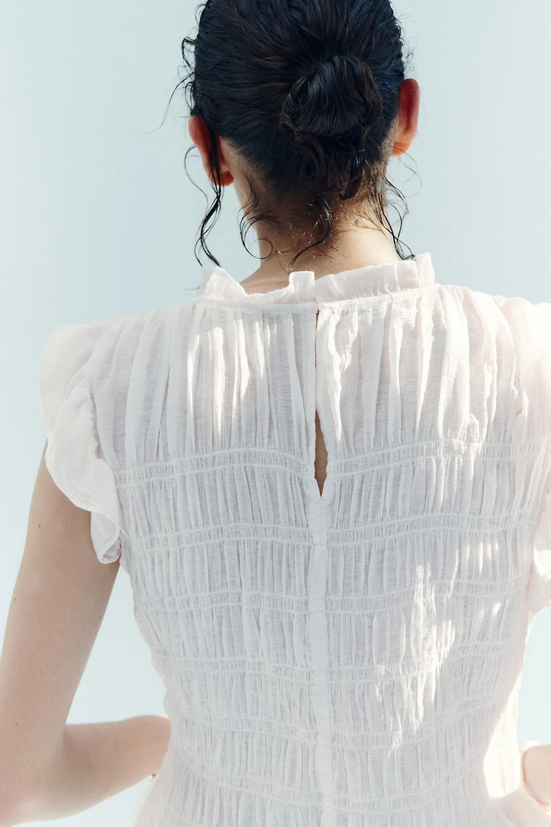 Haut péplum smocké