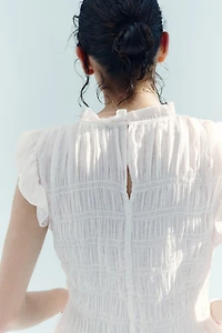 Haut péplum smocké