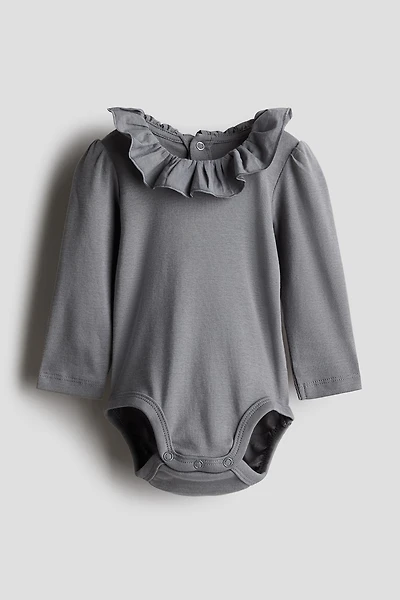 Cache-couche avec col à volant