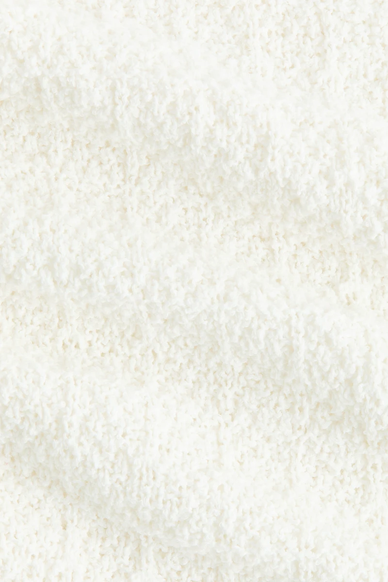 Haut péplum en tricot pointelle