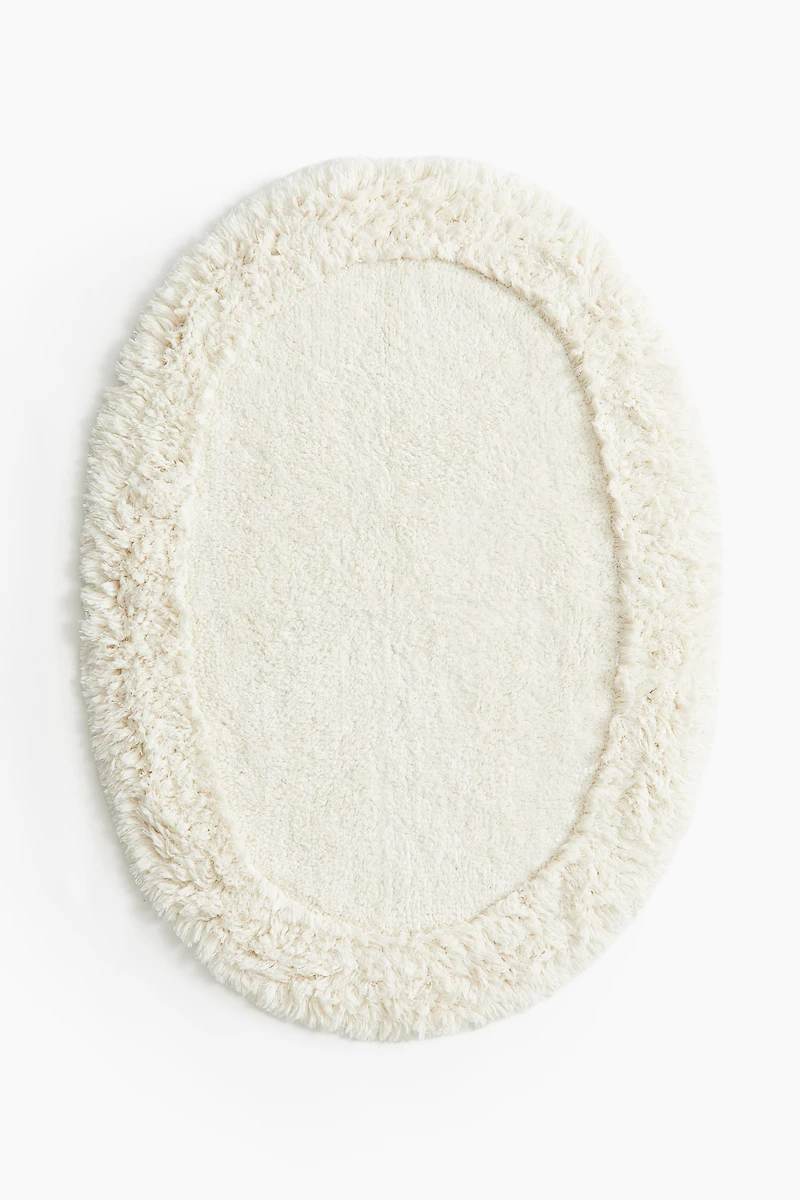 Tapis de bain ovale avec dessus touffeté