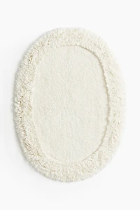 Tapis de bain ovale avec dessus touffeté