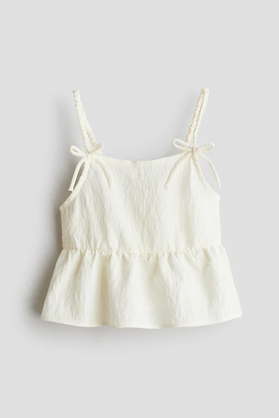 Haut péplum avec boucles