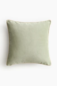 Housse de coussin en velours avec passepoil