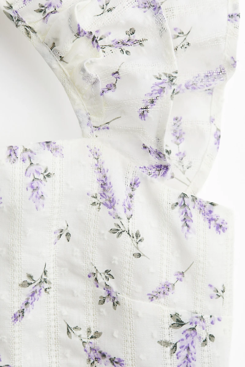 Blouse péplum avec détail à nouer