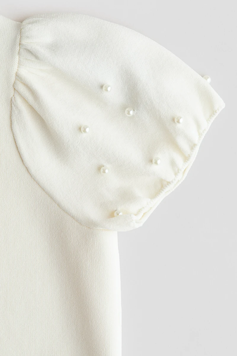 Haut en fin tricot avec perles de fantaisie