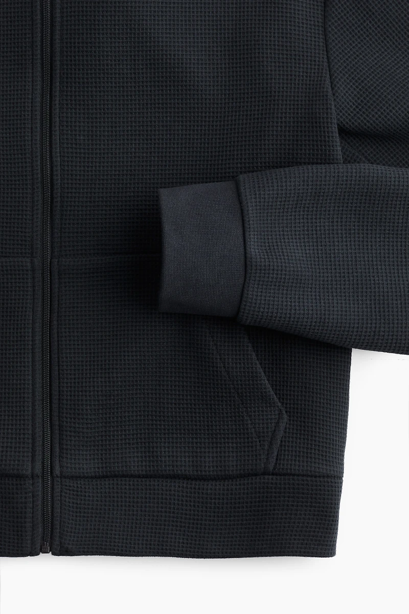 Veste gaufrée avec capuchon et glissière
