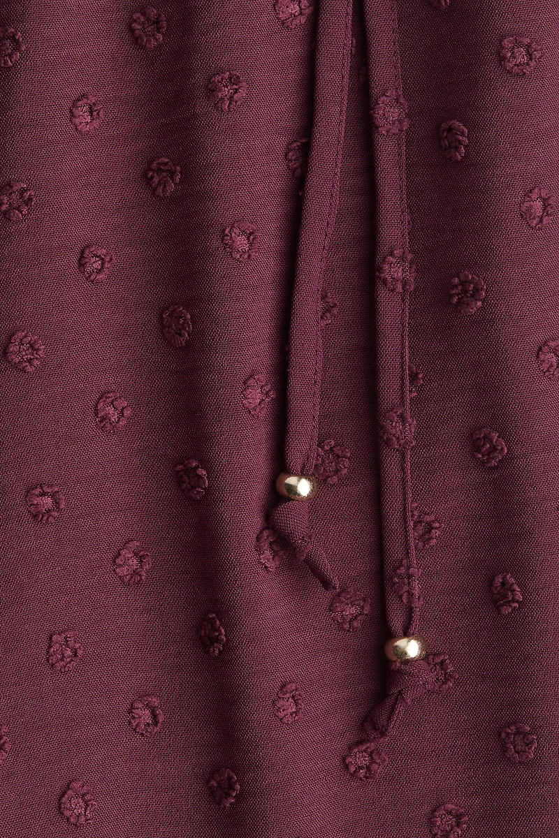 Pantalon en plumetis avec cordon de serrage