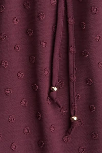 Pantalon en plumetis avec cordon de serrage