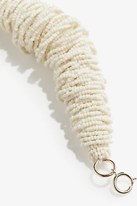 Bracelet iconique avec perles en verre