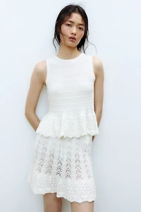 Haut péplum en tricot pointelle