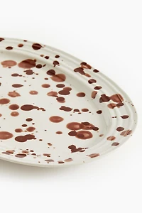 Assiette de service mouchetée en grès cérame