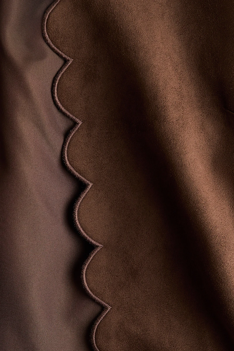 Veste à bords festonnés