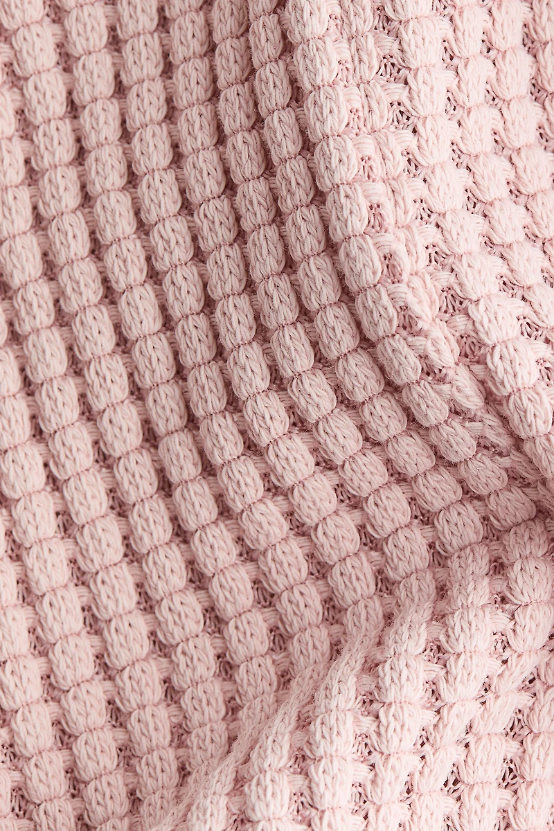 Barboteuse en tricot gaufré
