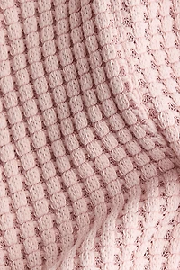 Barboteuse en tricot gaufré